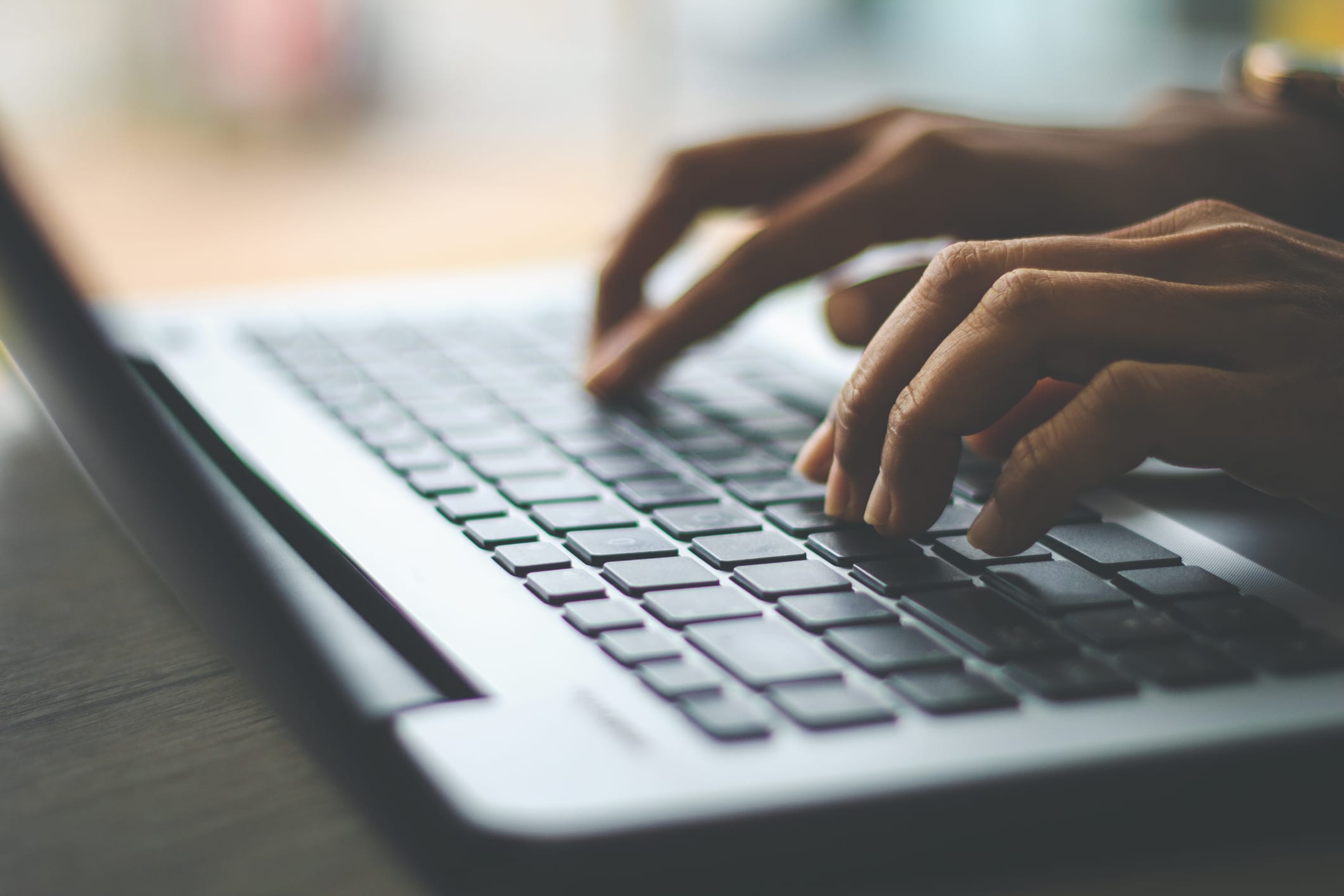 Businesswoman using laptop, searching web, browsing information, having workplace at office