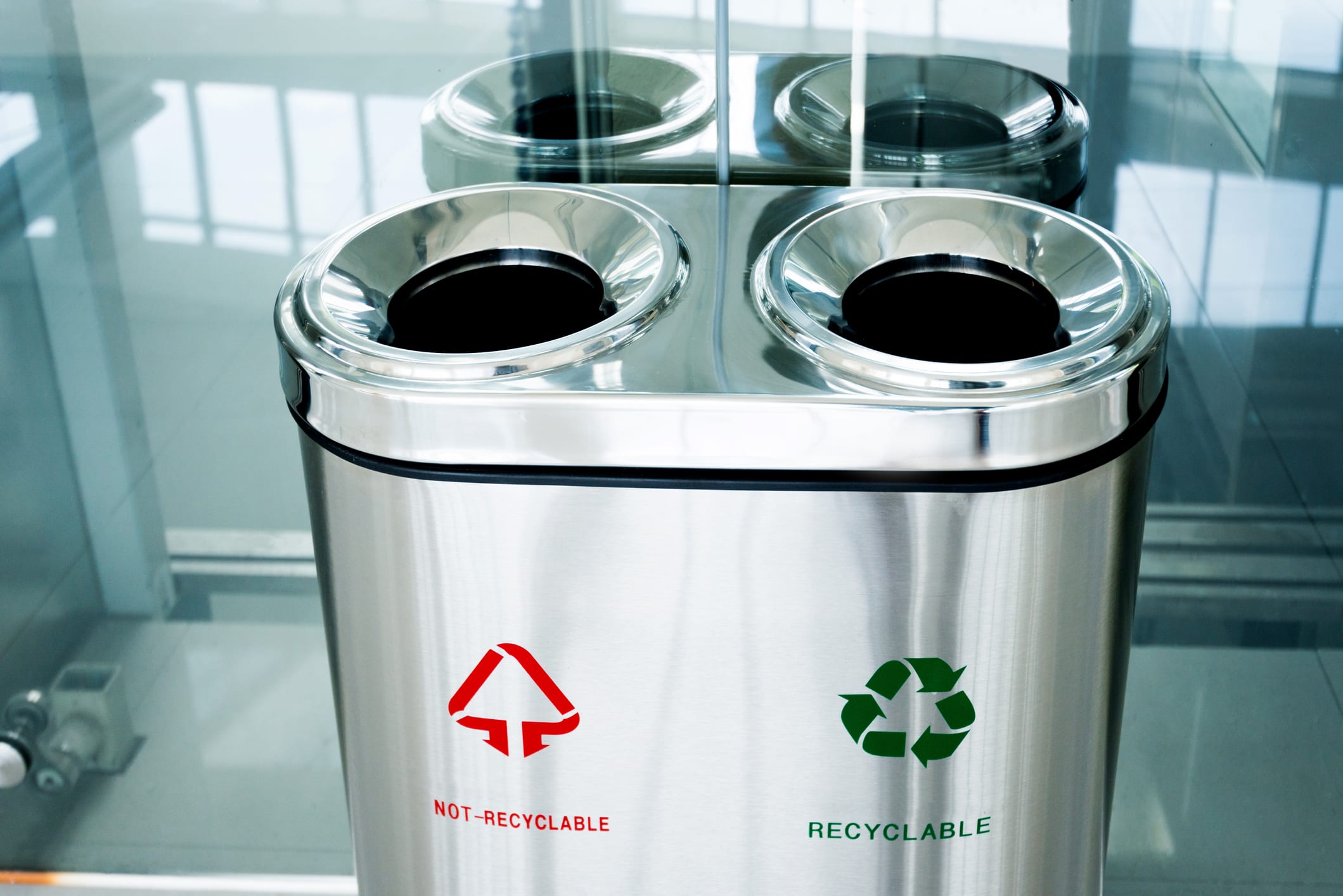 Recyclable and non-recyclable garbage can indoors.