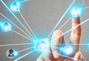 A hand touching a floating graphic of interconnected icons