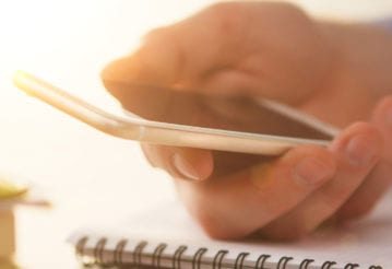 Close up of a hand holding a mobile phone