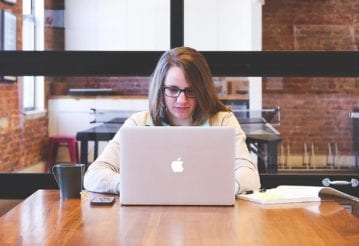 Woman looking at a laptop in a meeting room