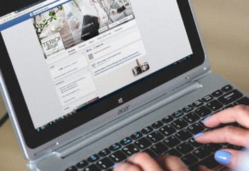 Woman using a laptop to browse facebook