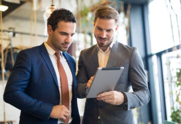 Two businessmen looking at a digital tablet