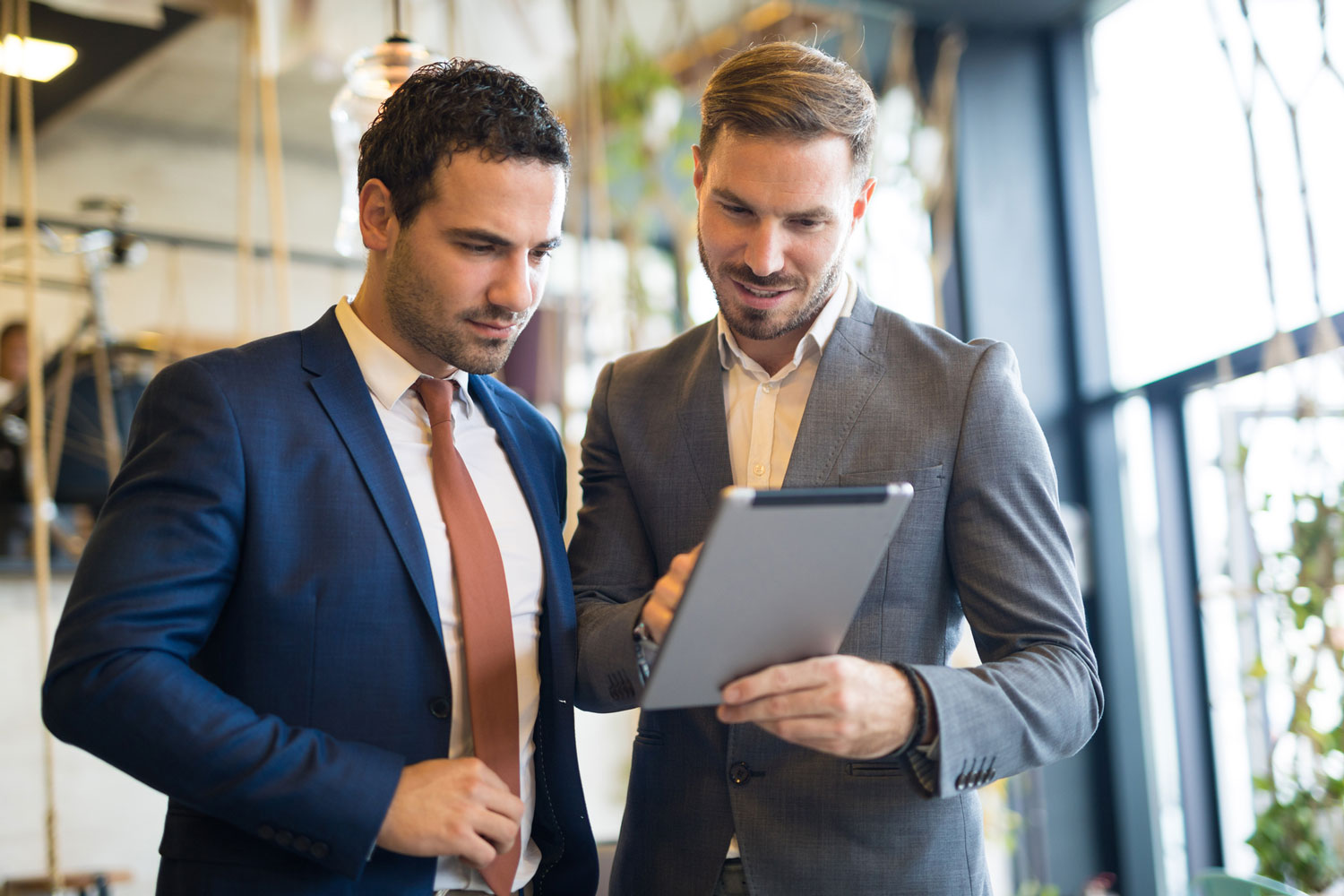 Two businessmen looking at a digital tablet