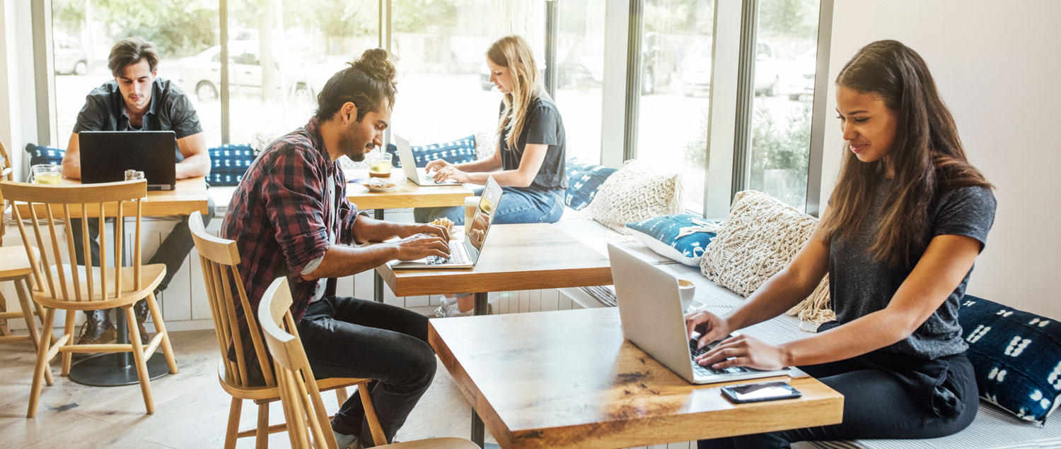 Group of people in a Café using laptops and mobile phones