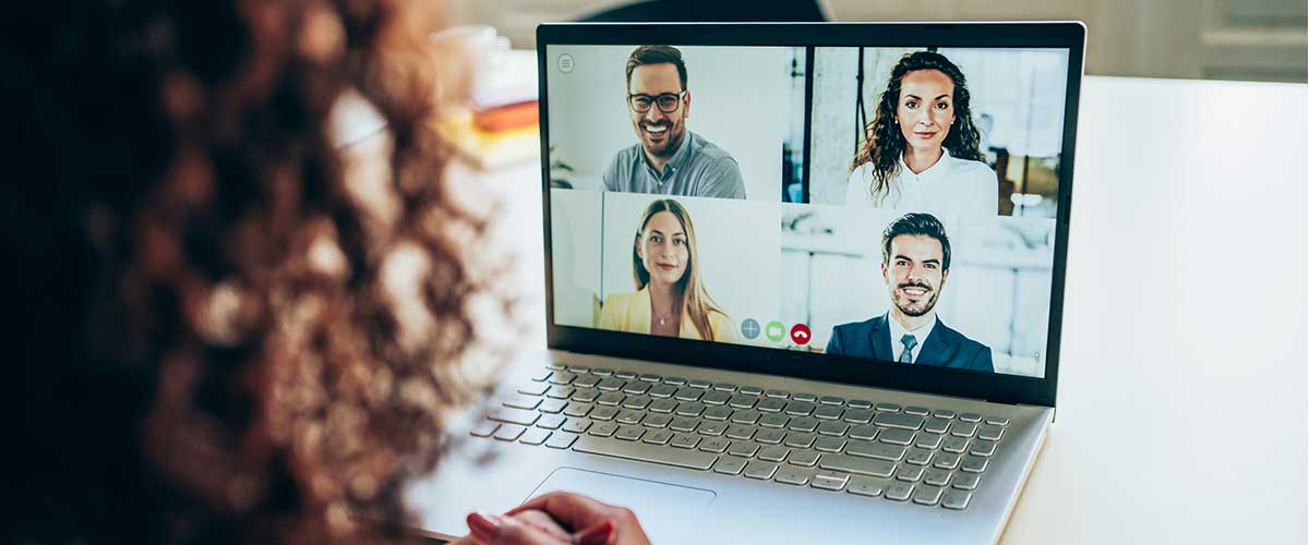 Woman participating in video meeting on laptop