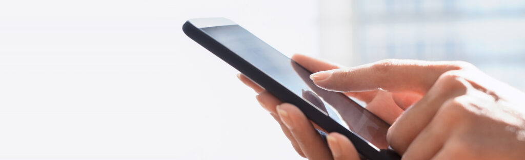 Close up of hands holding a mobile phone