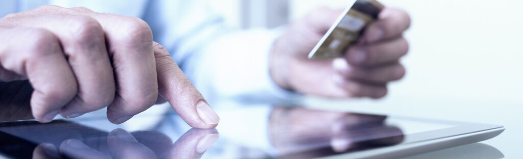 Man making an online purchase on his computer tablet