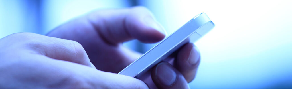 Close up of hands holding a mobile phone