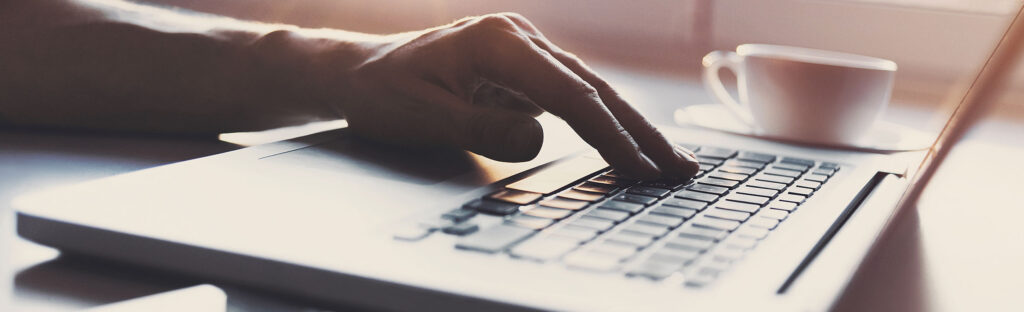 Hand on a laptop keyboard