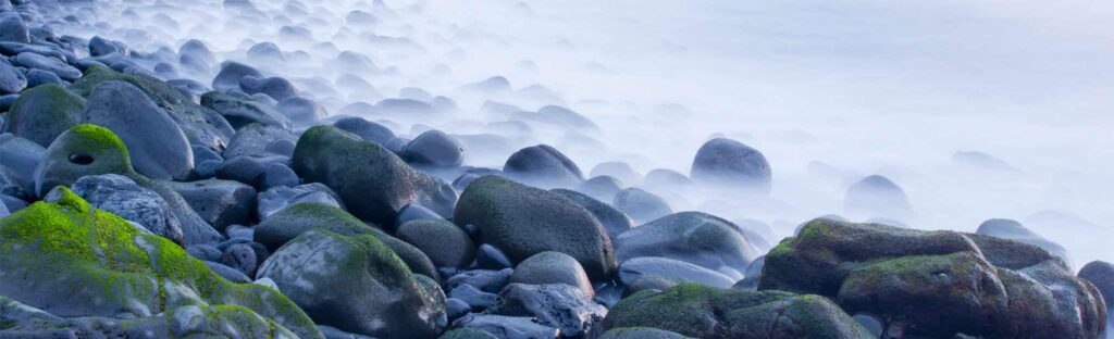 Wet round rocks covered by mist