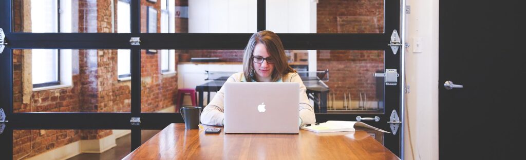 Woman looking at a laptop in a meeting room