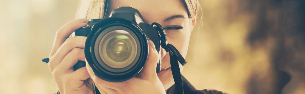 Woman pointing a camera at the viewer